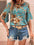 Printed round neck half sleeve blouse with floral design, paired with distressed denim shorts.