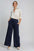 Umgee Drawstring Wide Leg Pants with pockets in navy, styled with button-up shirt.