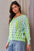 Two-tone ribbed hem openwork knit top with contrasting colors and exposed seam.