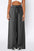 High waist wide leg pants with frill and pockets in dark color.