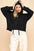 Davi & Dani drop shoulder hooded sweater with long sleeves in black.