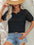 Round neck lace patchwork half sleeve T-shirt in black, semi-sheer with slightly stretchy fabric, worn with denim shorts.