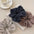 3-piece ruched heathered elastic hair scrunchy set in various colors on table.