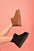 WILD DIVA Suede Round Toe Platform Booties in brown and black on a pink background.