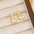 18K Gold-Plated Bubble Letter Stud EarringsMyMooiaTrendsiPieces: 1-pair
Material: 18K gold-plated, Copper
Care instructions: Avoid wearing during exercise, as sweat will react with the jewelry to produce silver chloride an18K Gold-Plated Bubble Letter Stud Earrings