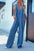 V-Neck wide leg denim jumpsuit made from 95% rayon and 5% polyester, featuring a washed look.