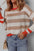 Contrast striped round neck drop shoulder knit top with beige and red accents.