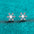 Moissanite 925 sterling silver snowflake shape earrings on blue background.