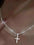 925 sterling silver cross necklace on model's neck.