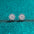 925 Sterling Silver Moissanite Zircon Stud Earrings on teal background.