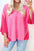 Exposed seam V-neck three-quarter sleeve blouse in pink.