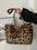 Faux fur leopard shoulder bag with chain strap and large size design.