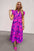 Full size ruffled printed notched cap sleeve midi dress in vibrant pink and purple floral pattern.