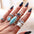 Turquoise Alloy 8-Piece Ring Set on hand display.