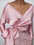 Pink surplice long sleeve blouse with tied bow detail.