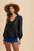 Annie Wear Tie Front Peplum Long Sleeve Denim Top featuring a stylish tie front and flattering peplum design.