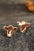 Bull Head Alloy Stud Earrings on stone surface.