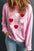 Contrast Heart Long Sleeve Sweatshirt in pink with multicolored heart designs.