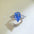 2 Carat 925 Sterling Silver Moissanite Teardrop Shape Ring with sparkling blue gem.