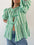 Tied round neck balloon sleeve shirt in green and white stripes.