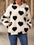 Fuzzy heart pocketed dropped shoulder hoodie with black heart pattern.