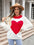 Woman wearing Angel Wings Heart Graphic Round Neck Sweater in white with a bold red heart design.