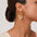 18K gold-plated stainless steel heart earrings on model.