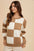 Annie Wear checkered round neck dropped shoulder sweater with a brown and white pattern.