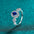 925 sterling silver moissanite ring with blue gemstone centerpiece.