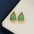 18K gold-plated zircon teardrop earrings on display surface.