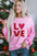 LOVE Sequin Dropped Shoulder Sweatshirt with "LOVE" print and sequin sleeves, pink color.