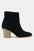 Beast Fashion suede point toe ankle booties with mid heel in black.