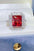 2 carat moissanite 925 sterling silver ring with red gemstone and diamond accents in box.