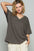 Flattering fit V-neck half sleeve T-shirt in dark color worn by a model.