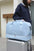 Large nylon wet separation travel bag on suitcase.