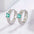 925 Sterling Silver Inlaid Zircon Earrings with intricate design and green gemstones.