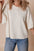 Pearl detail round neck half sleeve blouse in white paired with blue jeans.