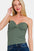 Zenana ruched twisted sweetheart neck top in green, flattering gathered bust design, paired with jeans.