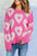 Pearl detail heart round neck long sleeve sweater in pink with heart patterns.