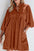 Corduroy quarter snap dress with three-quarter sleeves.