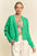 Davi & Dani open front drop shoulder cardigan in vibrant green, layered over a floral top.