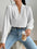 V neck long sleeve white top, polyester, worn with jeans.