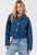 Cropped denim jacket with button-down front and patch pockets.