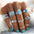 Artificial turquoise alloy ring 10-piece set displayed on fingers.