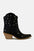 Beast Fashion faux leather boots with star-shaped cutouts and point toe design.