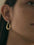 18K gold-plated stainless steel contrast asymmetrical earring on ear.