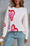 Angel Wings Heart Round Neck Long Sleeve Sweater with pink and red heart design, paired with blue jeans.