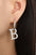 Titanium Steel Letter Hoop EarringsMyMooiaTrendsiPieces: 1-pair
Material: 18K gold-plated, Titanium steel
Care instructions: Avoid wearing during exercise, as sweat will react with the jewelry to produce silver chlTitanium Steel Letter Hoop Earrings