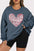 Plus size sweatshirt with heart sequin design and round neck.