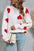 Angel Wings Heart Round Neck Dropped Shoulder Sweater with red heart pattern, highly stretchy, paired with jeans and a small bag.